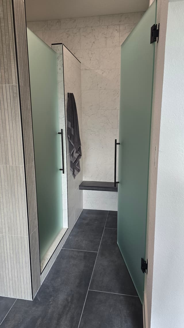 Luxury bathroom with LED lighting and large format tile