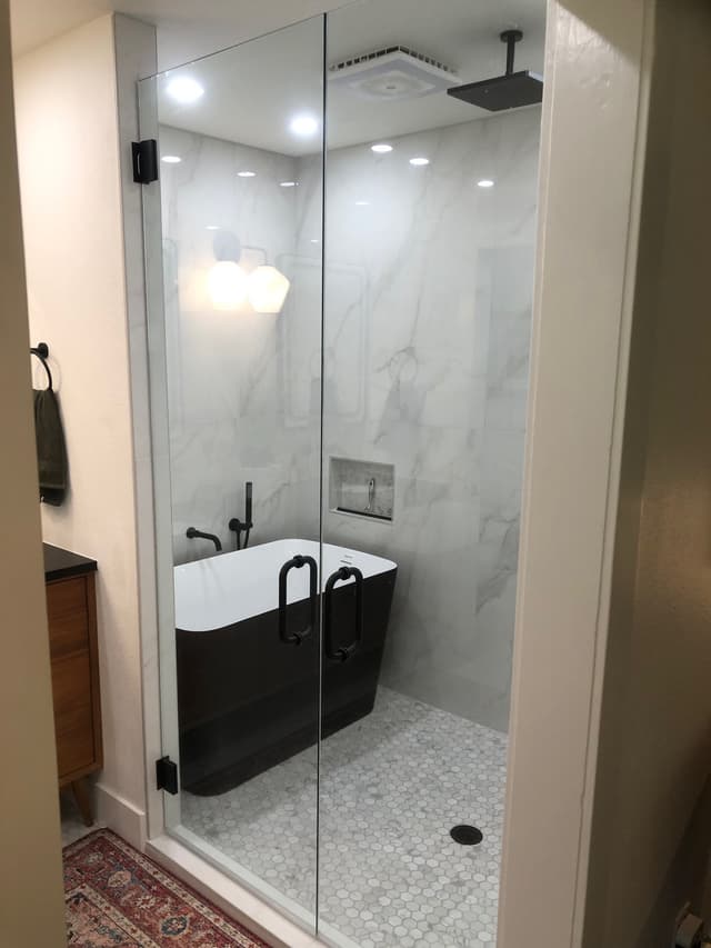 Luxury bathroom with marble walls and black fixtures