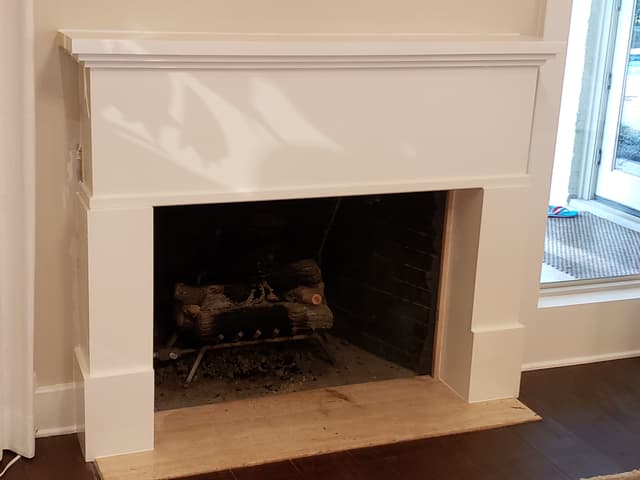 Custom fireplace mantel with white trim