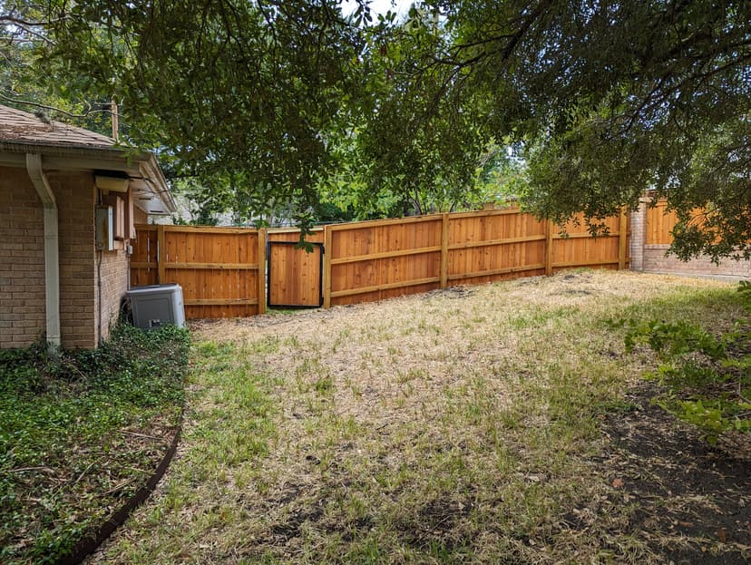 Custom fence gate with decorative hardware in Boerne