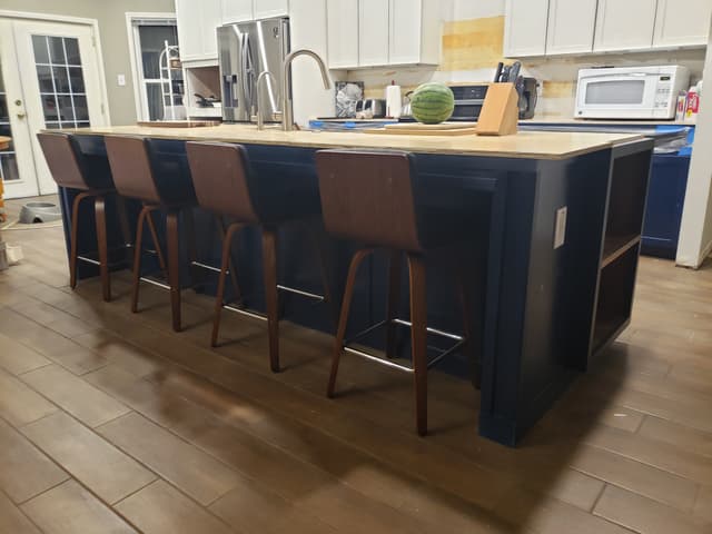 Kitchen island with custom cabinetry and pendant lights