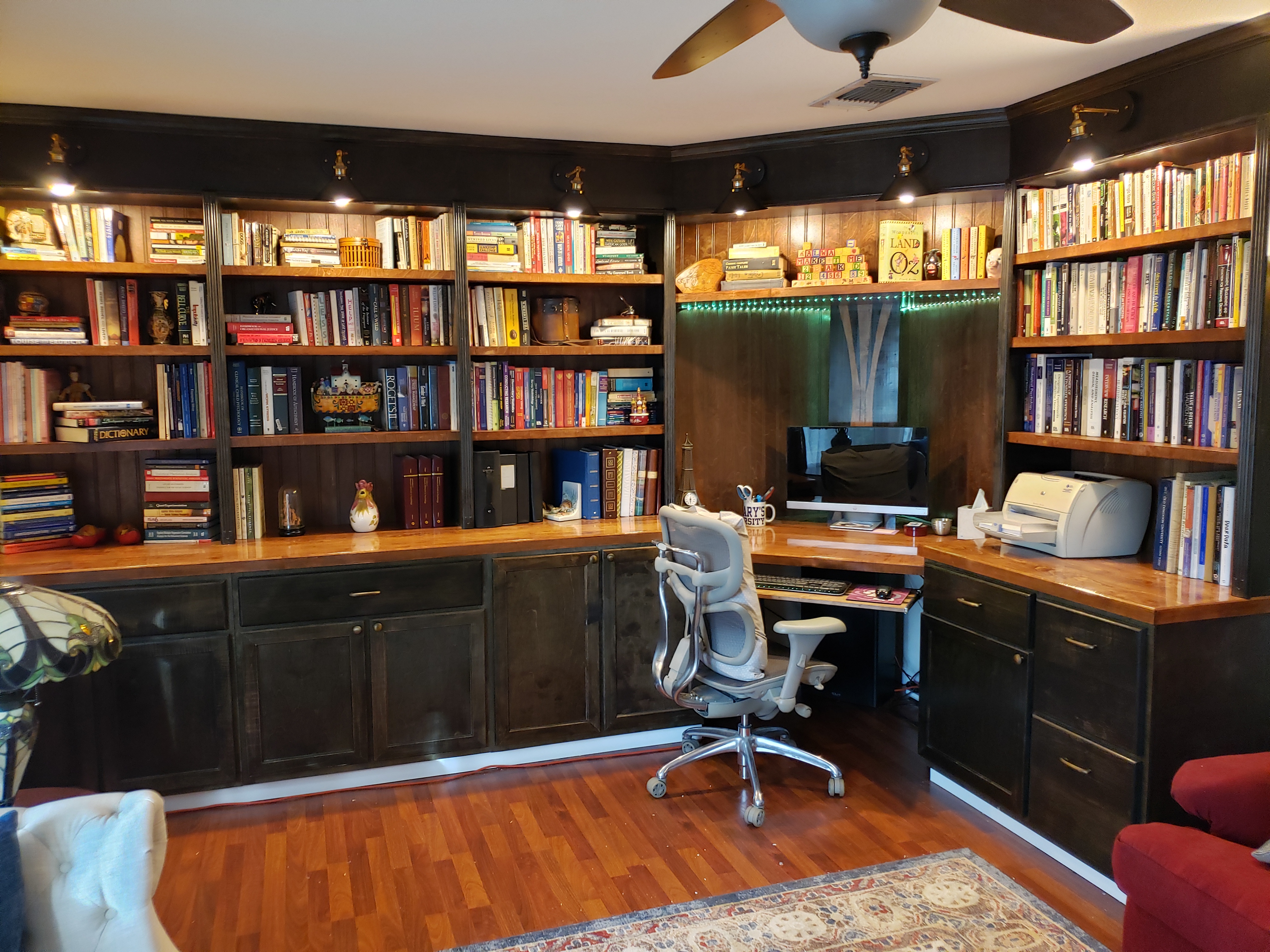 A custom-built library with integrated desk, showcasing detailed carpentry and built-in shelving.