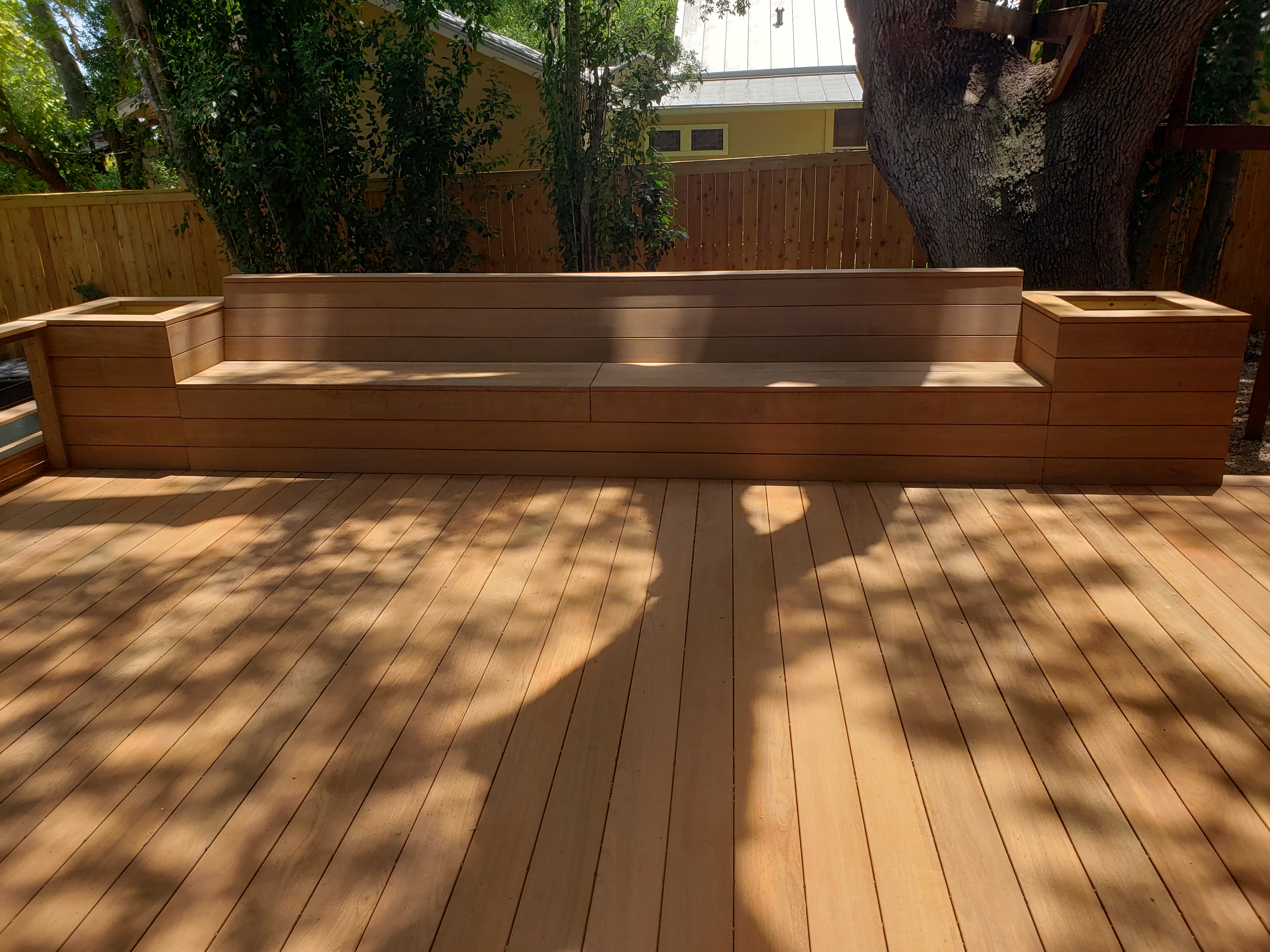 Custom cedar deck with built-in bench and planters