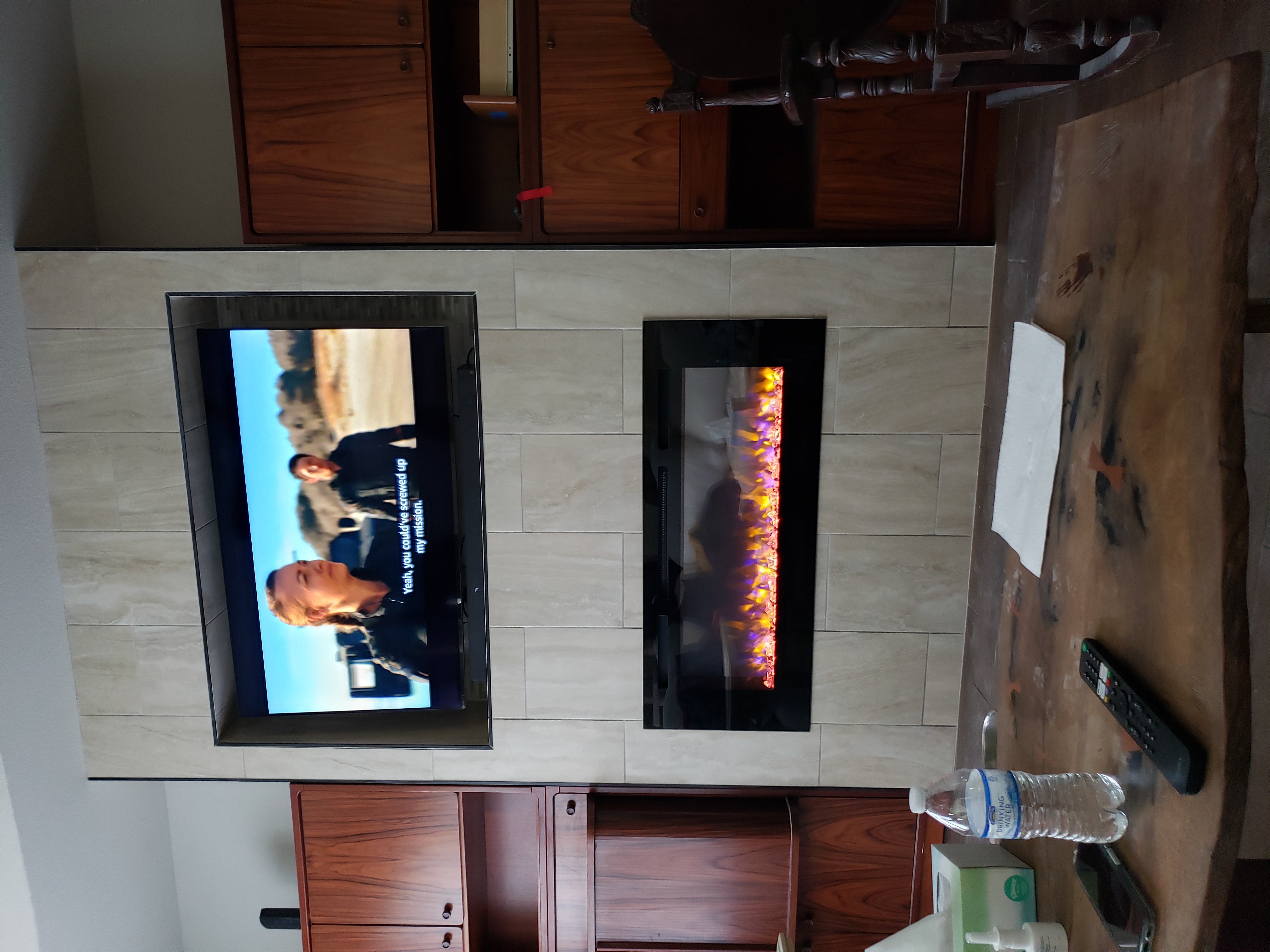 Custom entertainment center with fireplace surround in walnut finish, showcasing quality craftsmanship